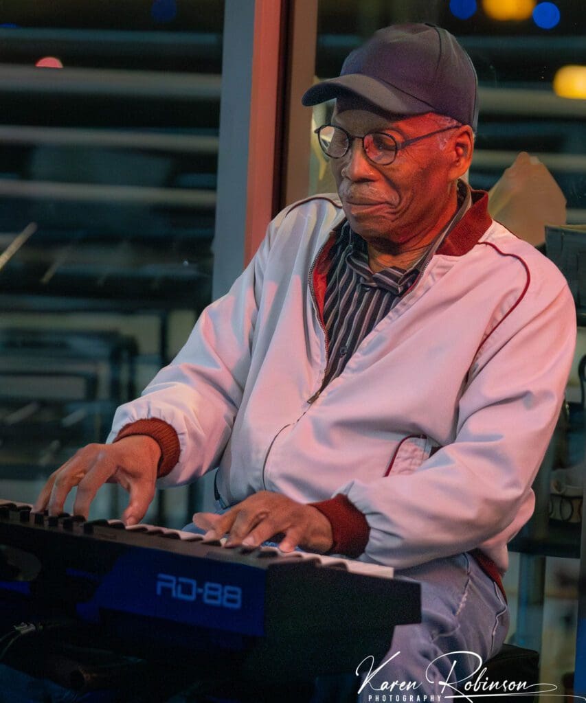 A man playing the keyboard on stage.