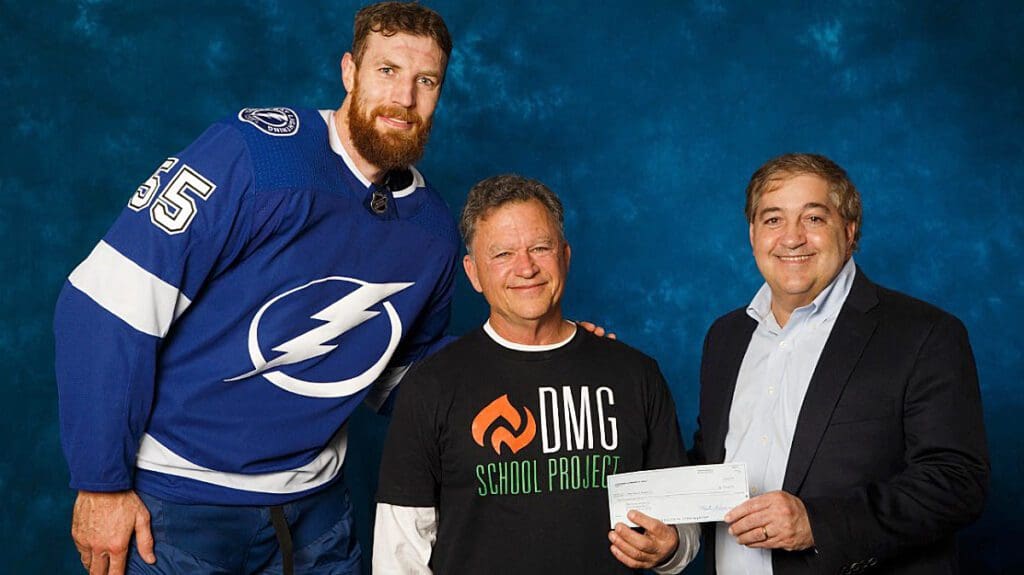 Duncan McClellan accepts donation check from Vinik.